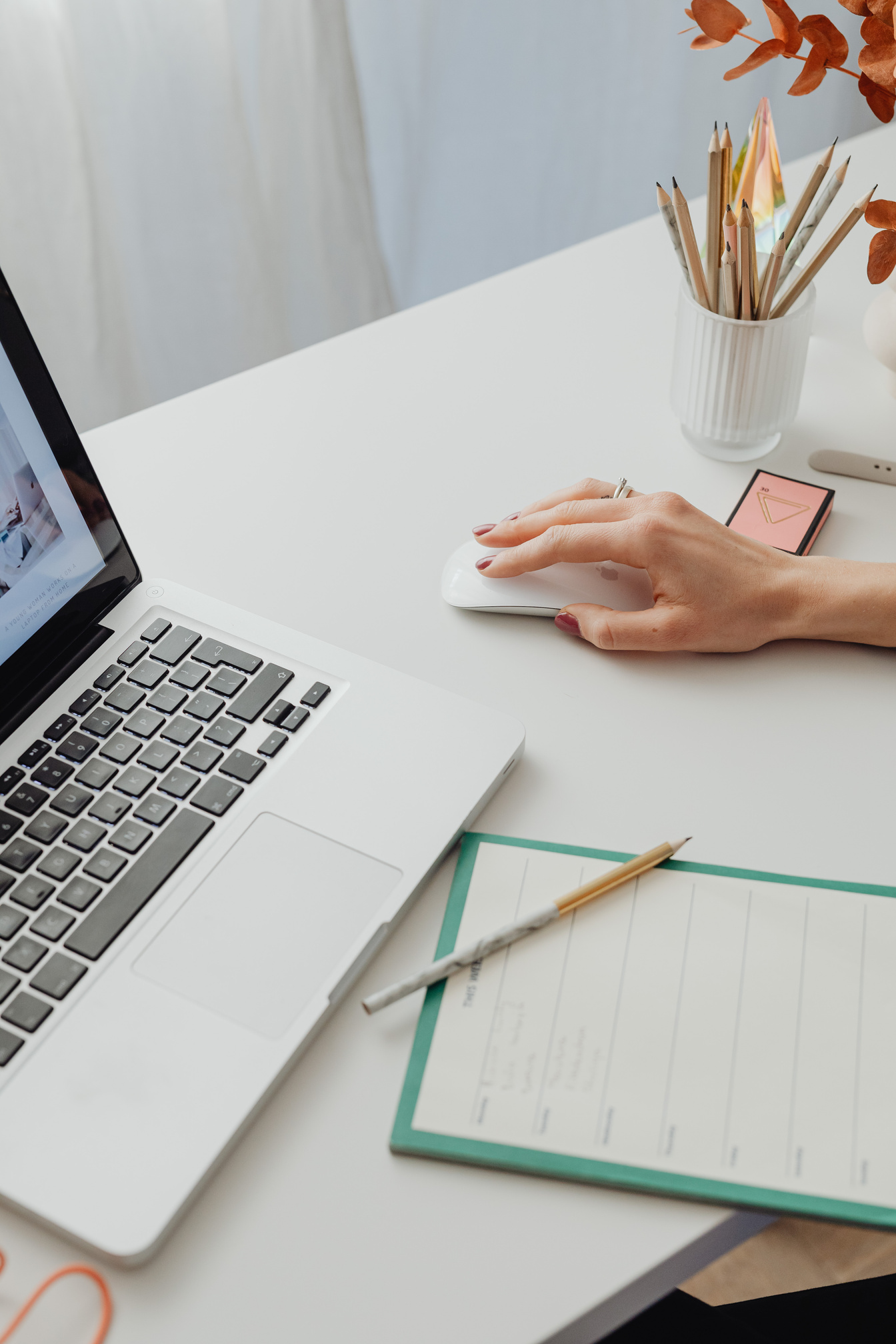 Person Using Laptop on White Table